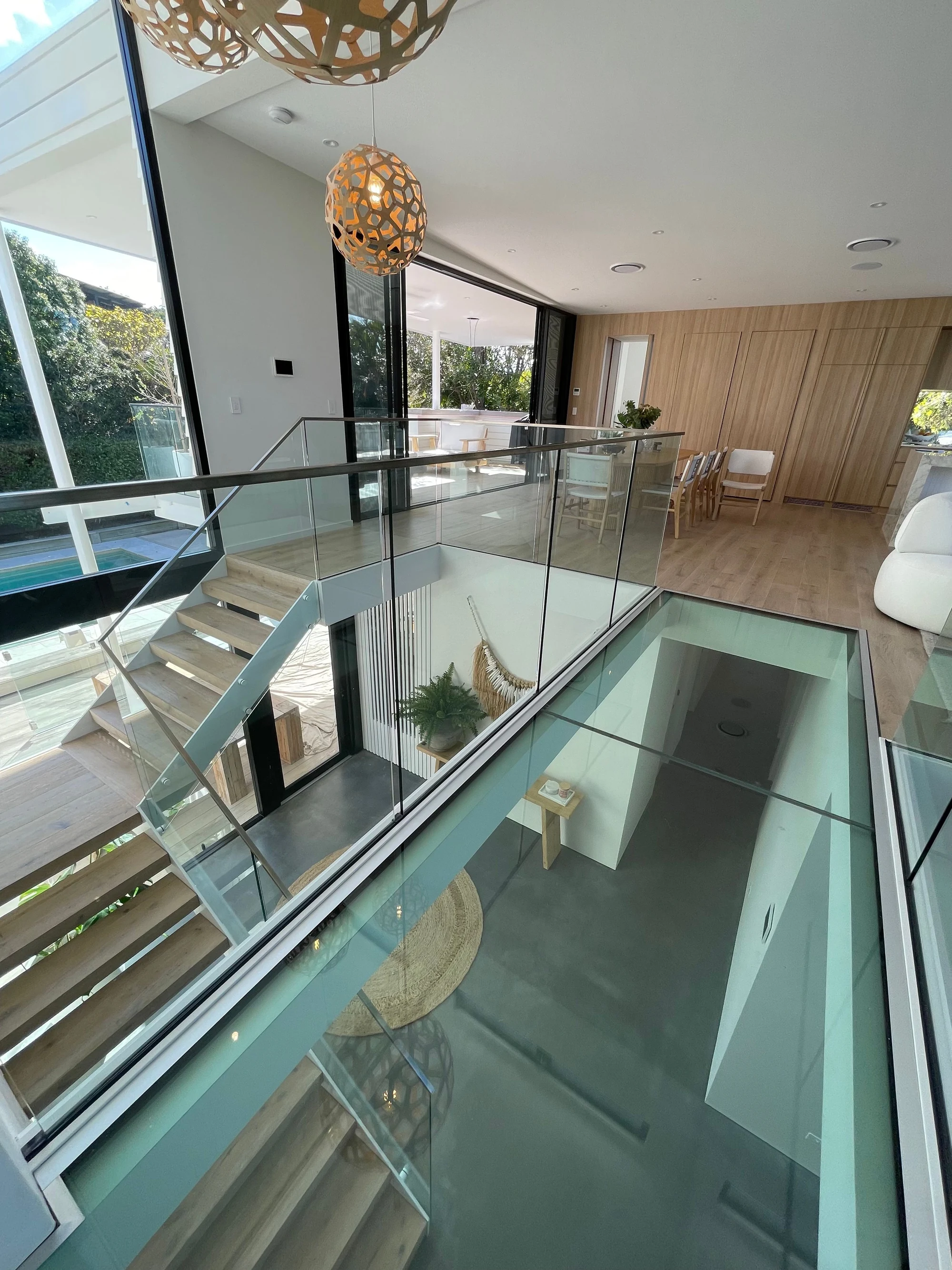 Glass balustrade and timber joinery surrounding the stair void