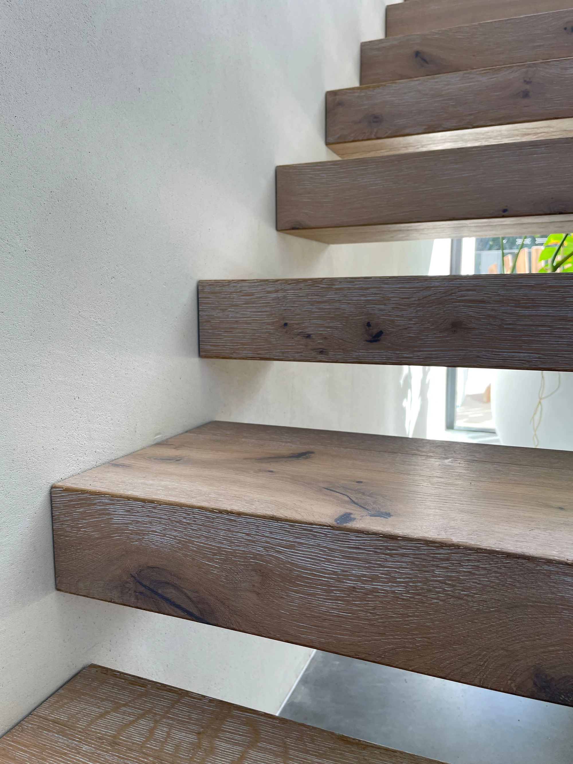 Solid timber stair treads and textured walls at Bevilja House