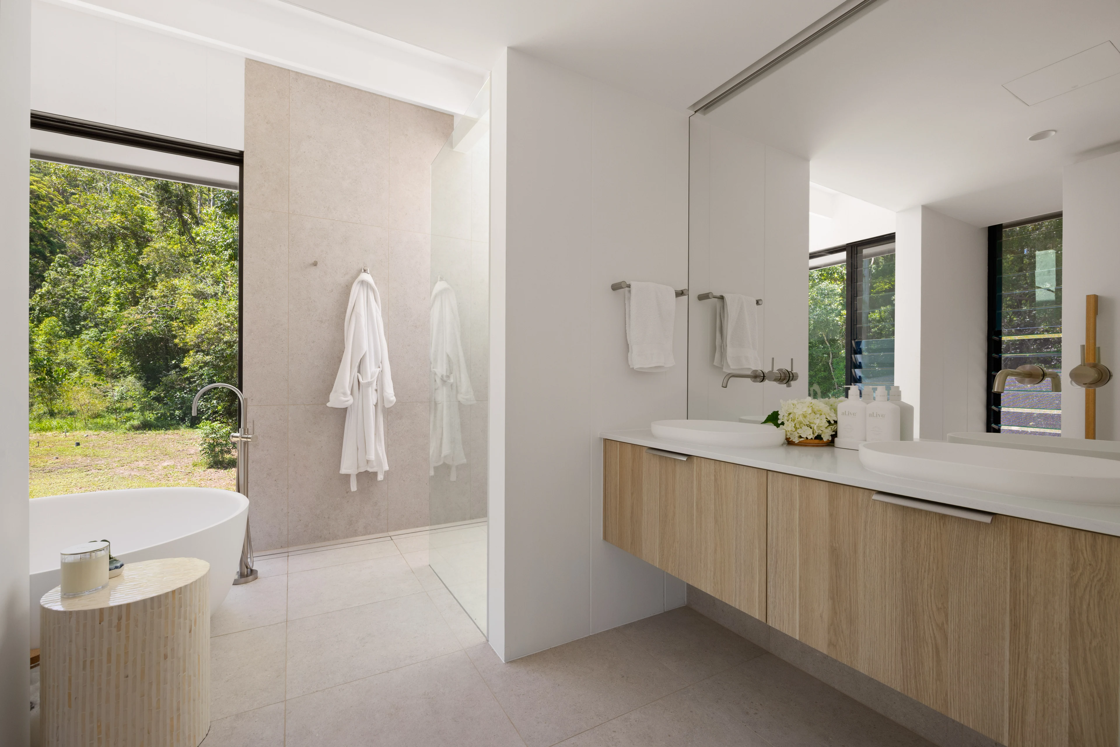 Timber vanity and garden-facing bathroom at De Wald Haus