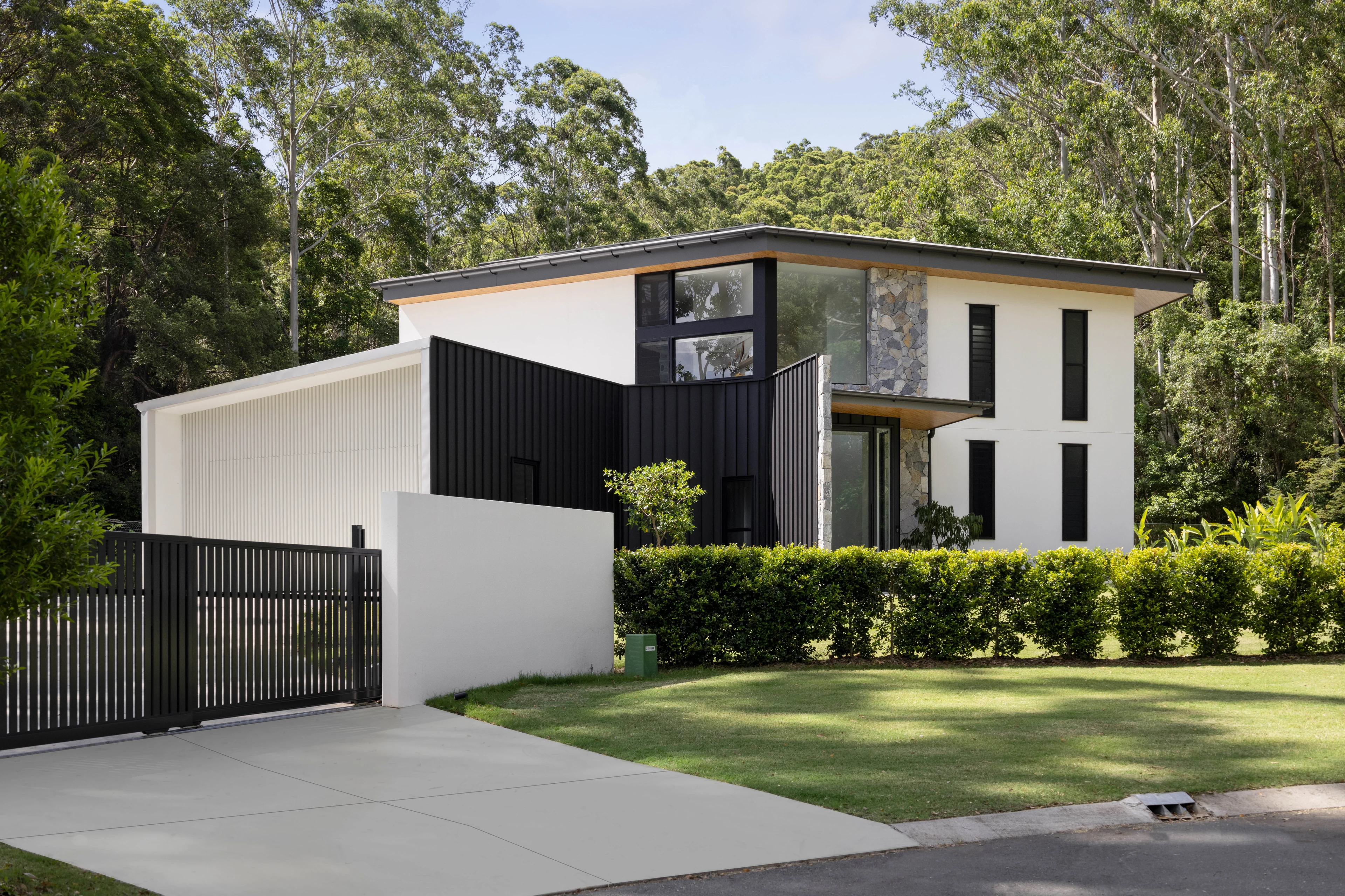 De Wald Haus, framed by established trees in Forest Glen
