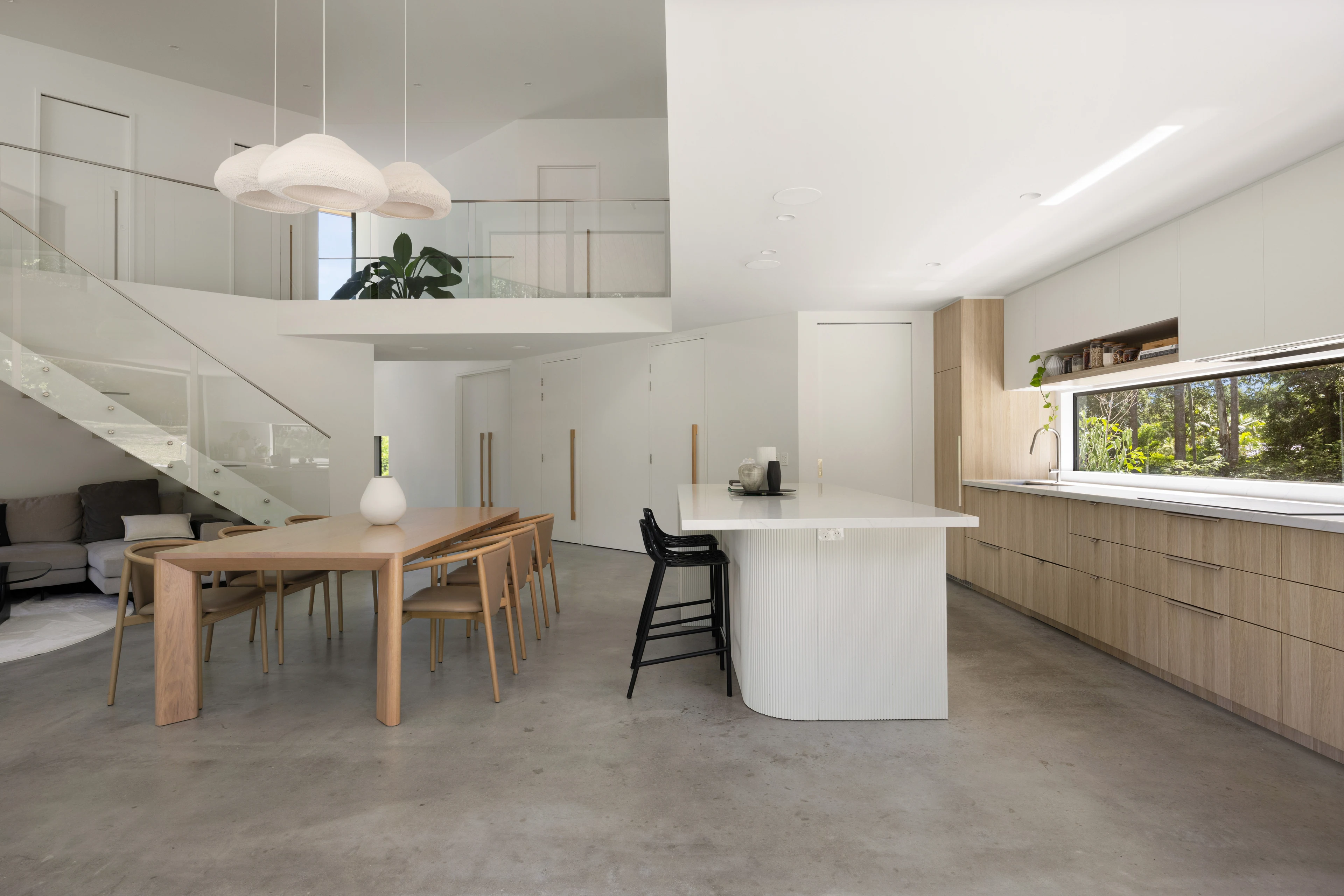Double-height dining and living spaces at De Wald Haus