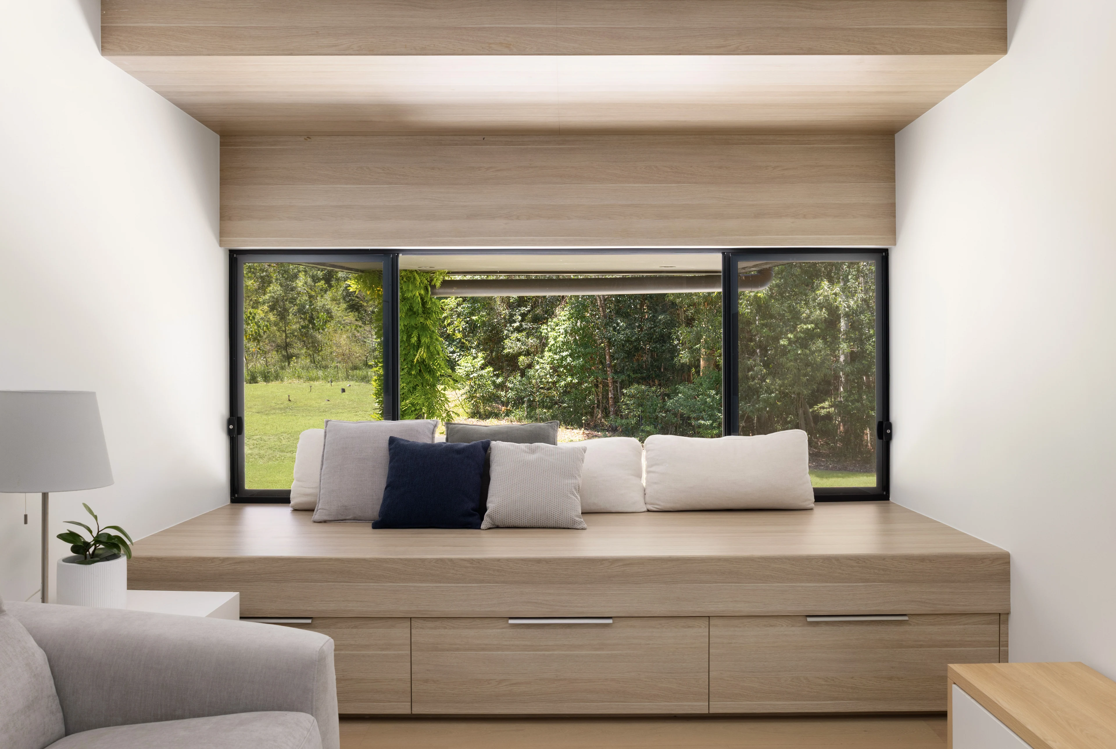 Timber window seat framing the forest at De Wald Haus