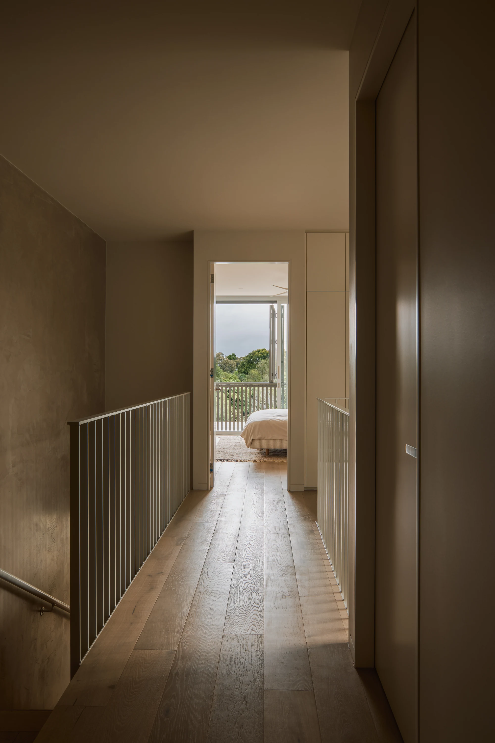 Palmera upper hallway with timber floors and warm textured walls