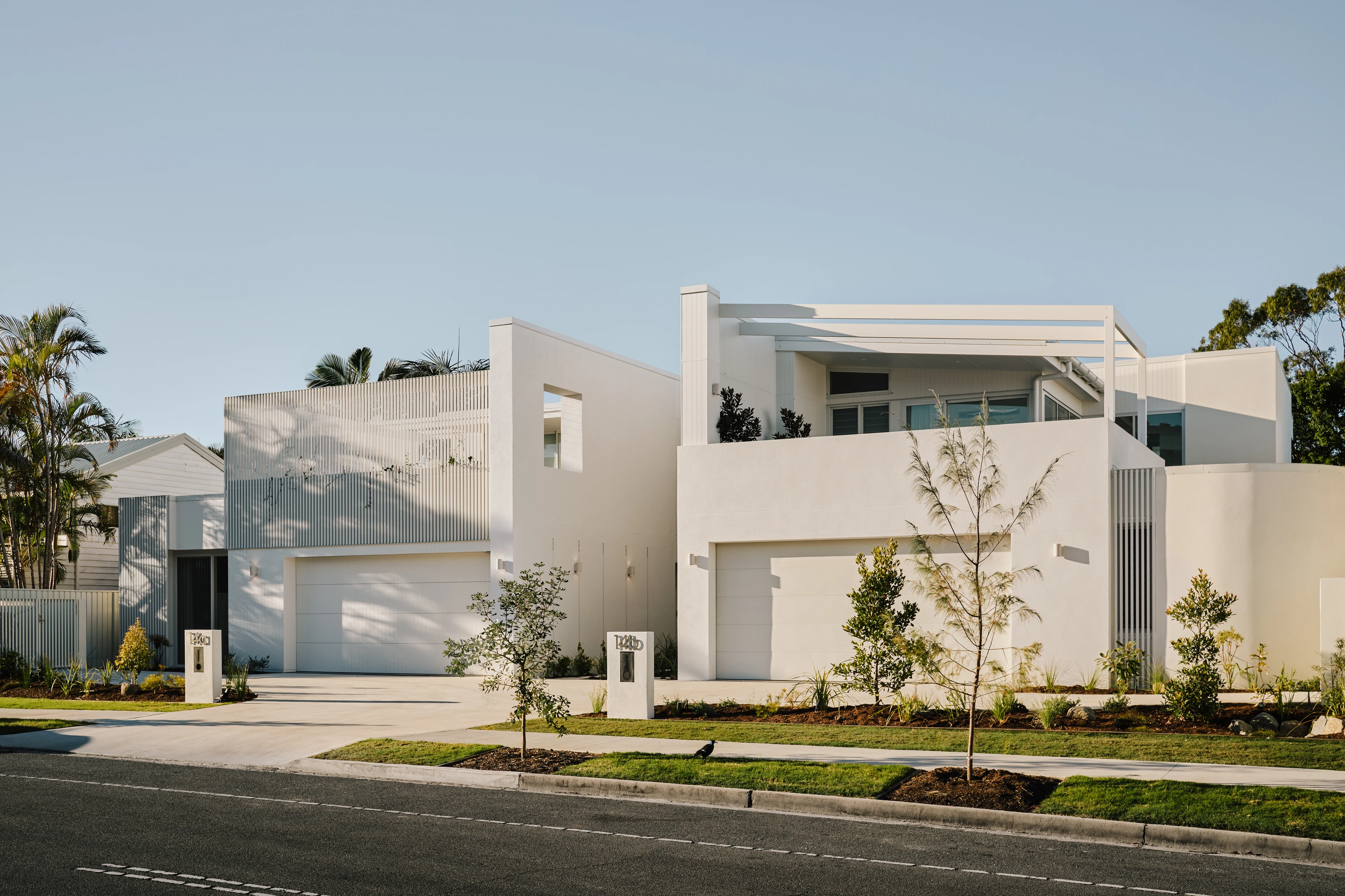 Wyandra beach houses with pale brickwork and sculpted balconies