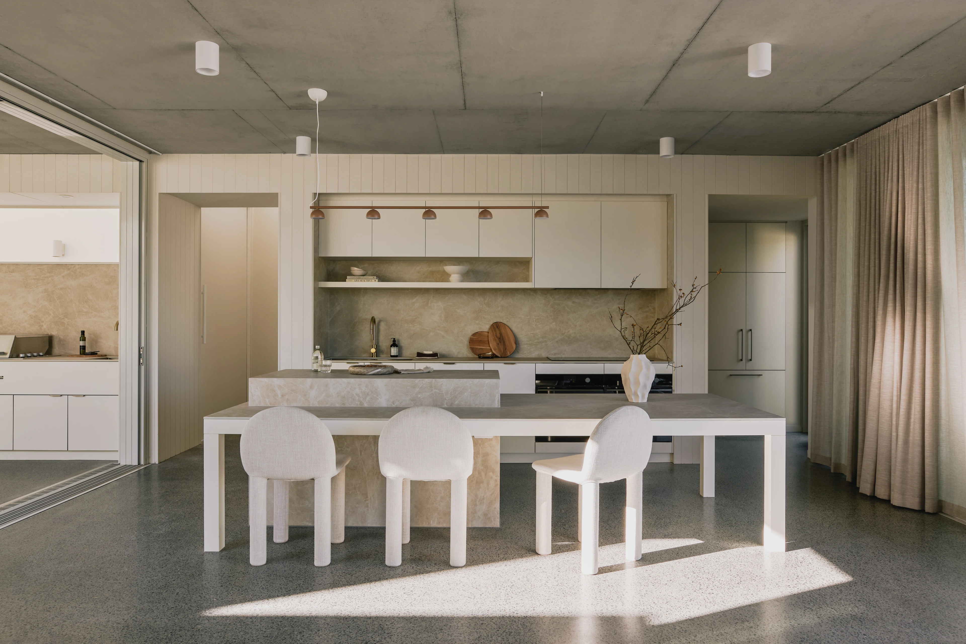 Kitchen island and dining area in warm natural light