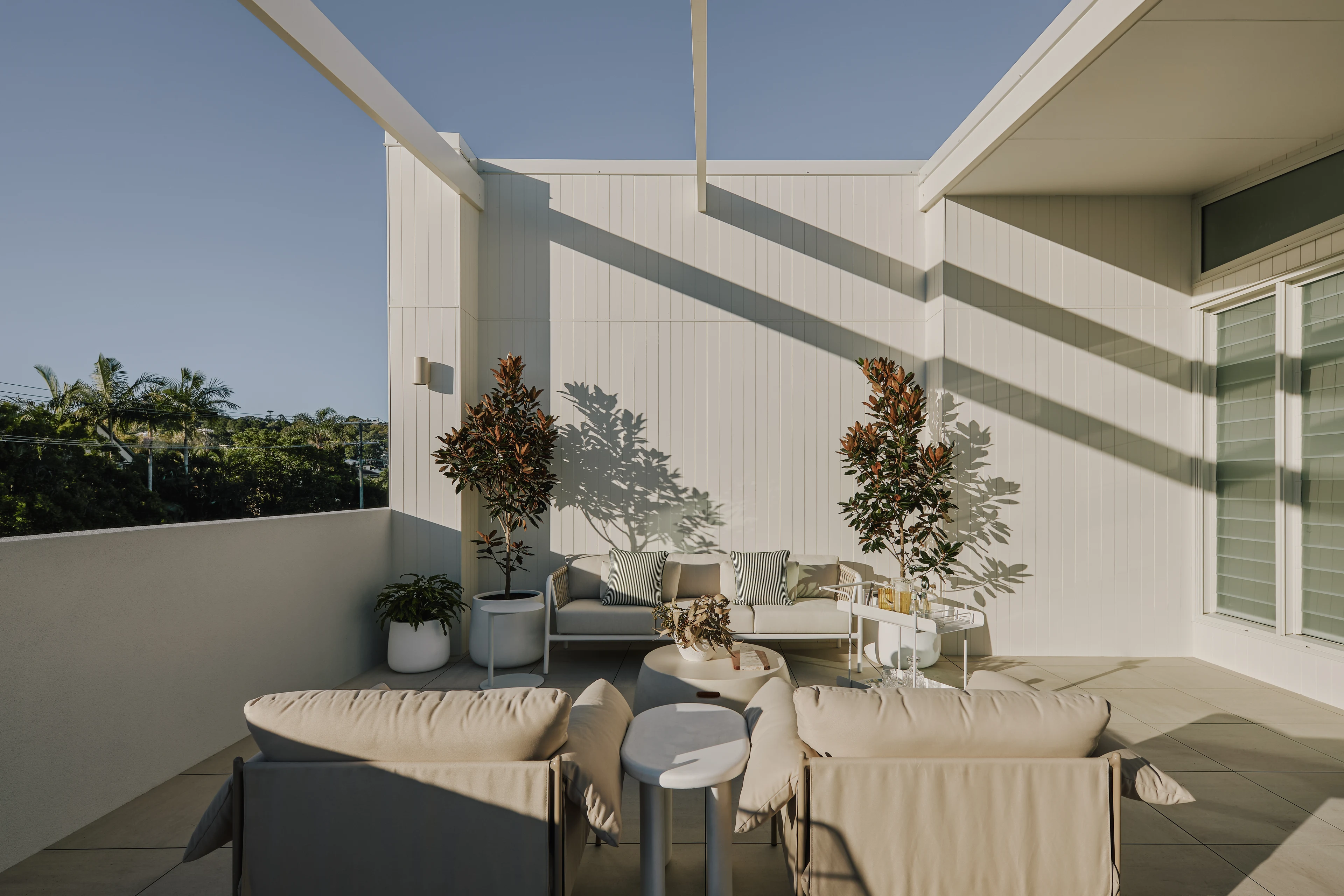 Outdoor dining terrace with architectural shadows